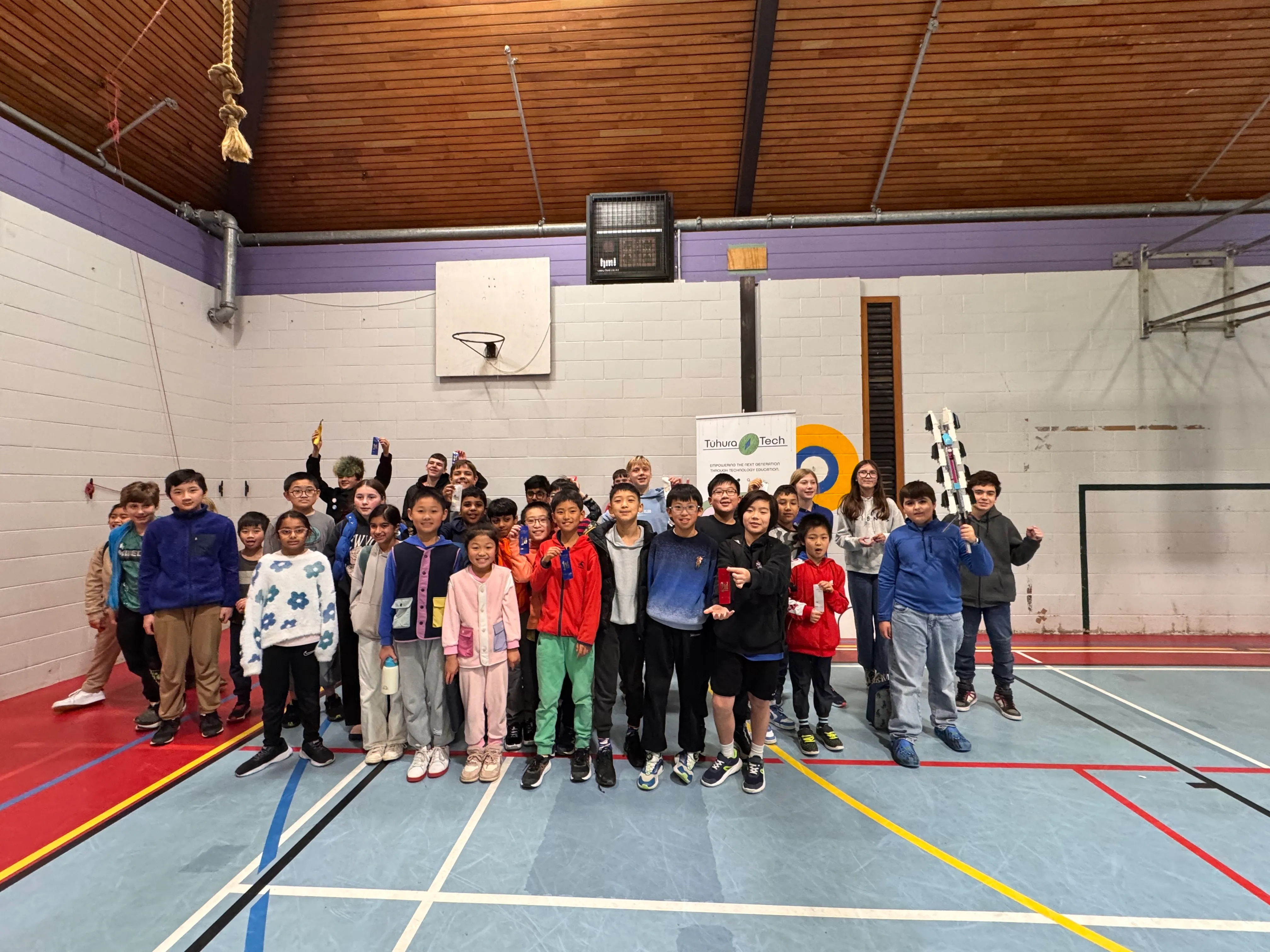 Rangatahi participating in RoboCup 2025 robotics competition with robots on display