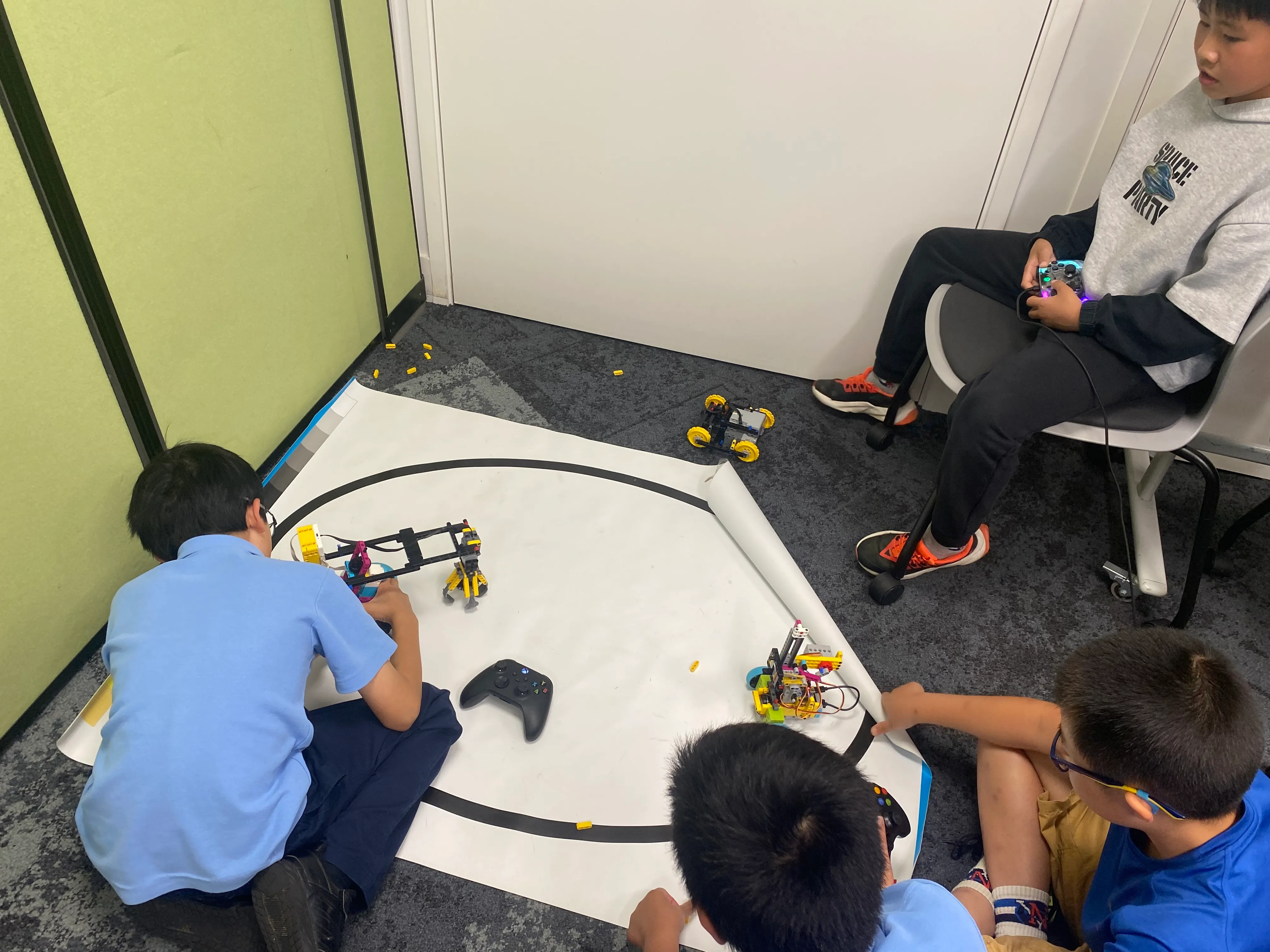 Rangatahi engaged in hands-on learning with computers and technology equipment